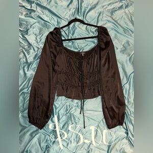 Silk black blouse. Ties up in the front. Size XL in women’s.